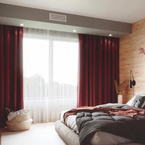 Bouche de gainable réversible au plafond d’une chambre, pour le chaud comme le froid